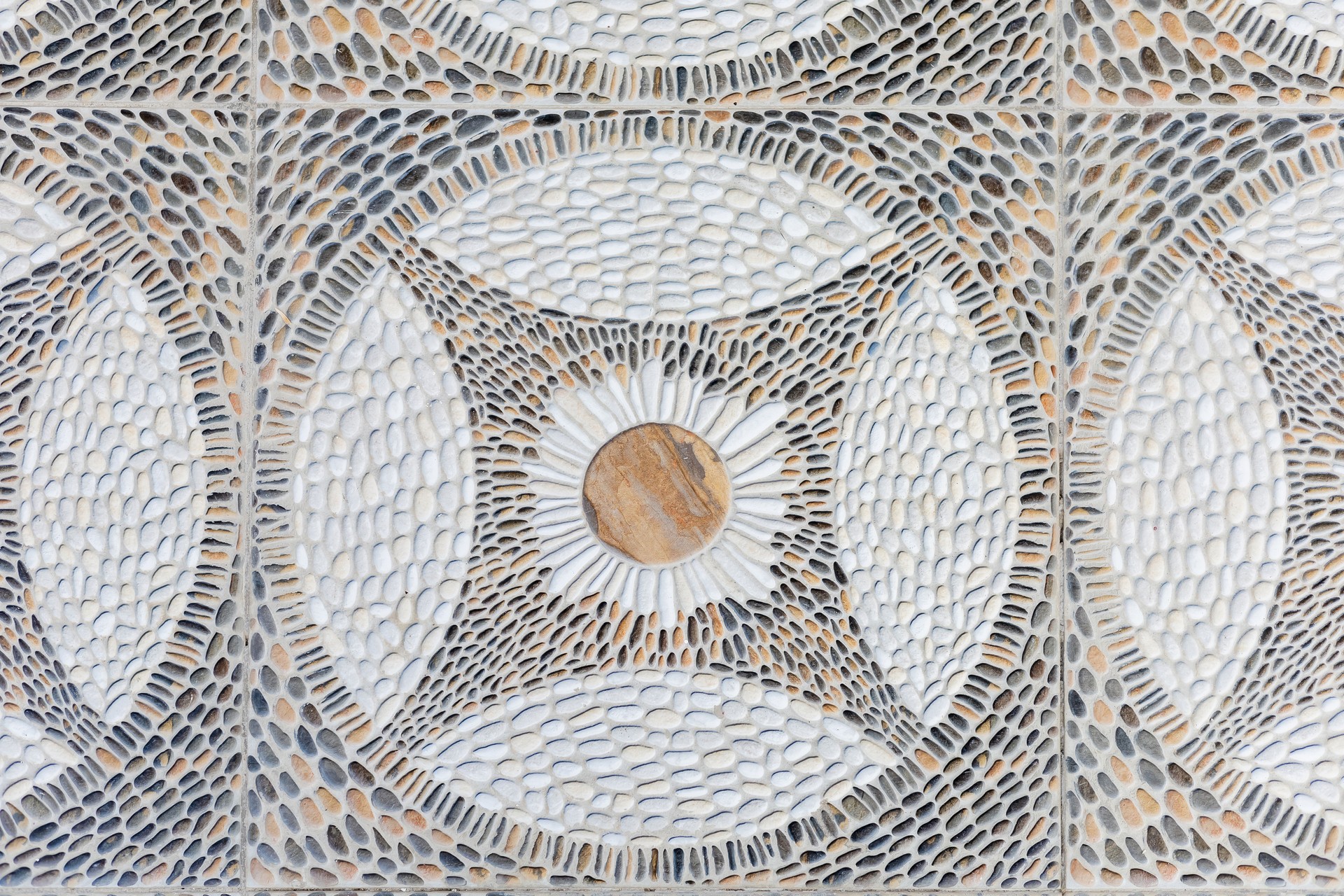 Geometric stone mosaic pattern close-up with intricate pebble detailing