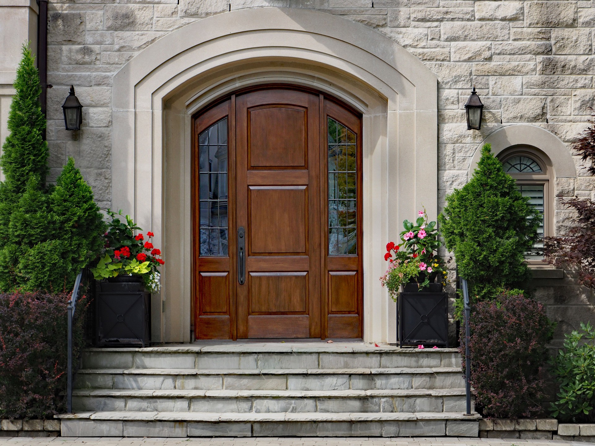 elegant front door of stone house with flagstone steps