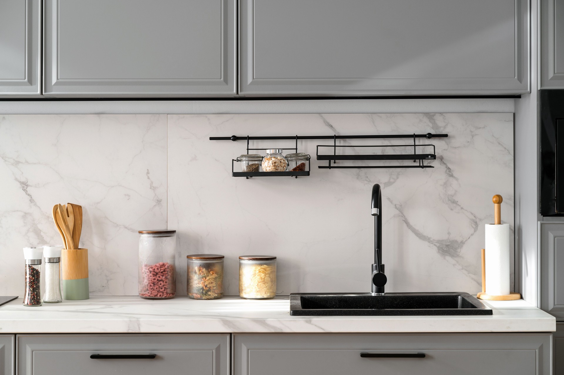 Marble countertop with black sink near light ceramic wall